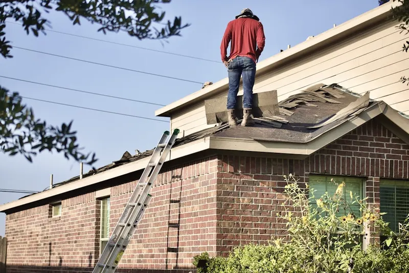 Professional roofer working on a residential roof in Meadowview Acres